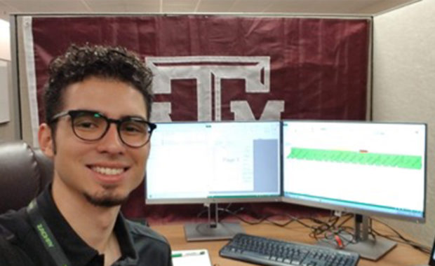 Luis Moreno sitting at desk at summer internship