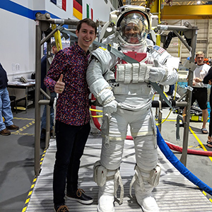 Jake Cooper standing with person in space suit
