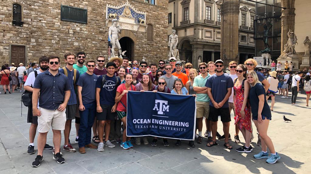 Student group photo with ocean engineering flag