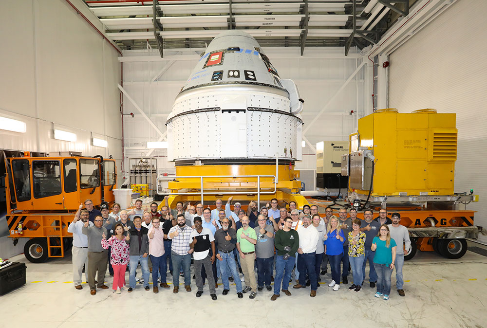 Group photo in front of space ship