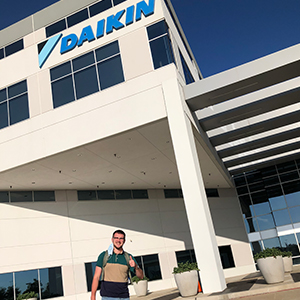Brandon standing in front of the Daikin building.