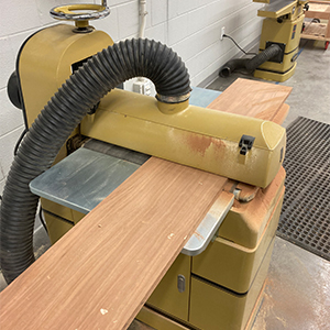 A machine cutting a piece of wood