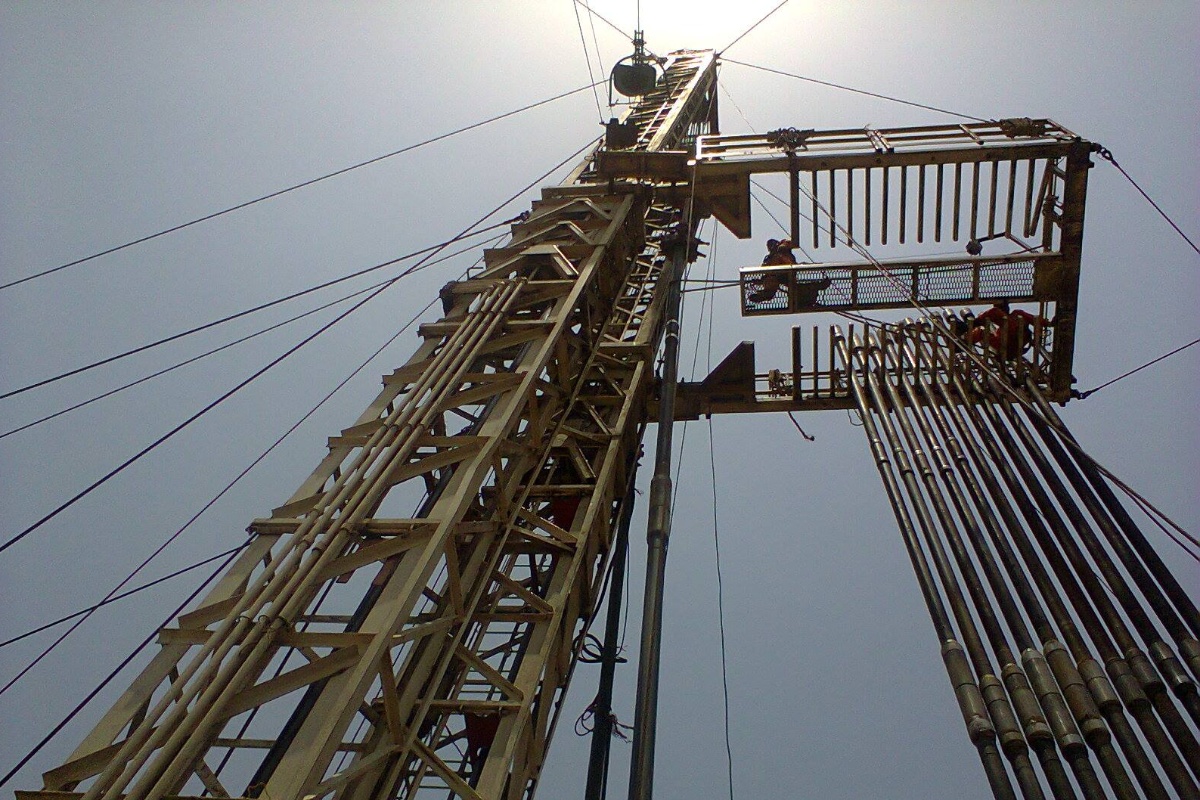 view looking up into the sky of an oil rig