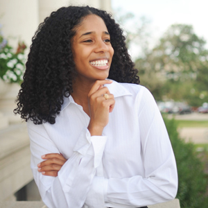 smiling young woman standing outdoors on Texas A&M University campus