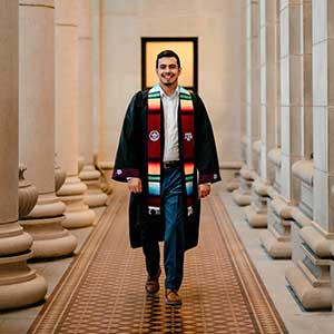 First generation Aggie posing in graduation regalia