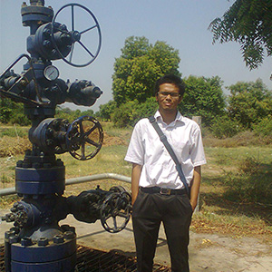 Prakhar Sarkar standing outside in front of pipe valves