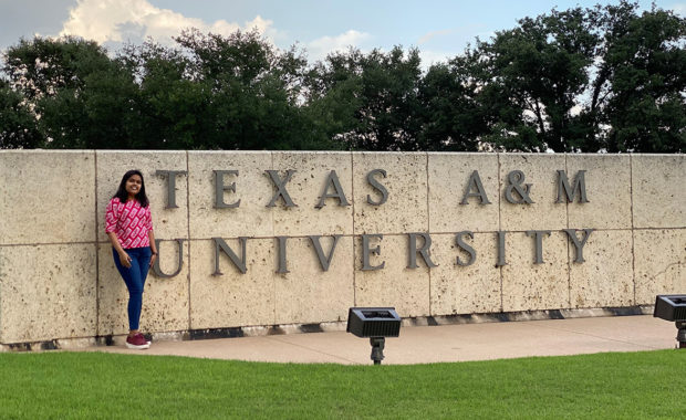 Engineering student, Dakshika Srivastava, standing in front of Texas A&M University sign
