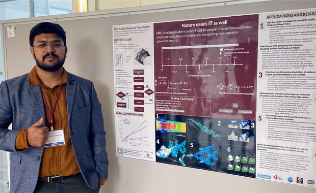 Student Vishal Indivar Kandala standing next to a poster research project