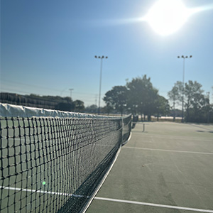Up close view of a net on a tennis court