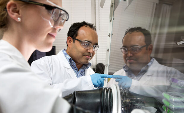 Ingenium blogger Vishal Kandala working with a female lab partner on equipment in a research lab
