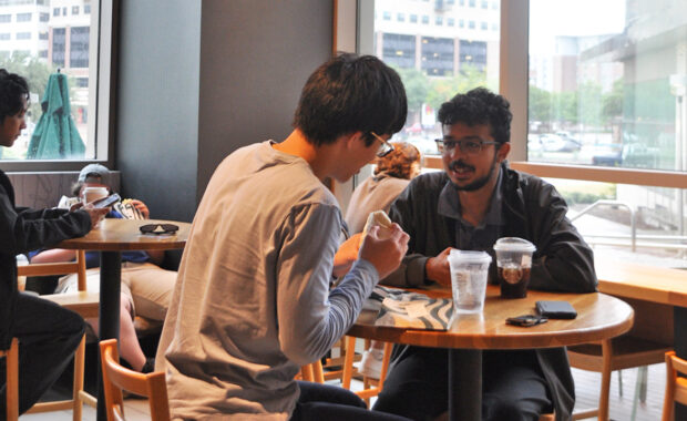 Students eating and talking in a coffee shop