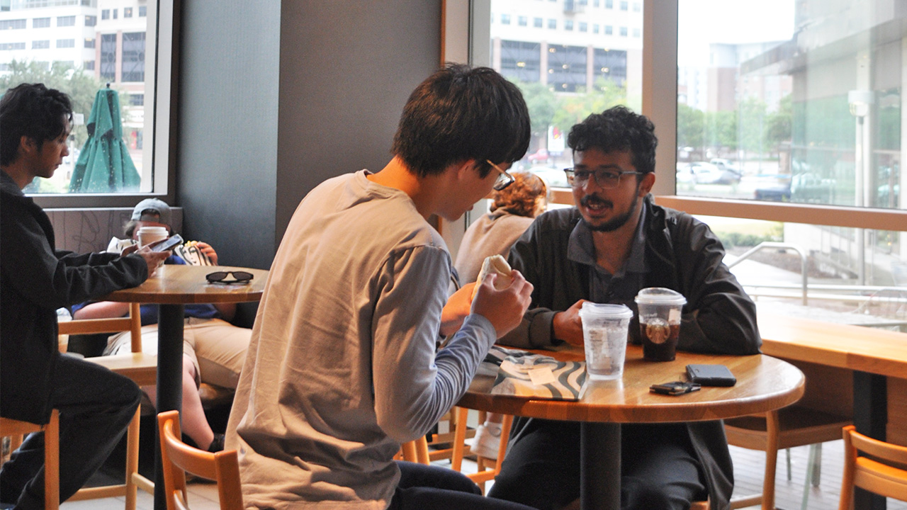 Students eating and talking in a coffee shop