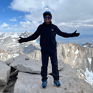 Akshaj "Akku" Kumar on top of a snowy mountain