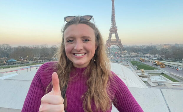 Bailey Sizemore standing in front of the Eiffel Tower