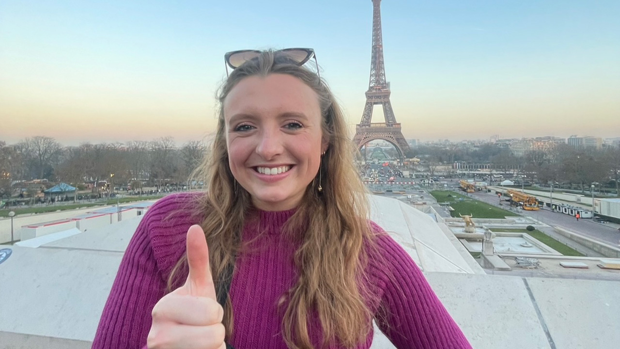 Bailey Sizemore standing in front of the Eiffel Tower