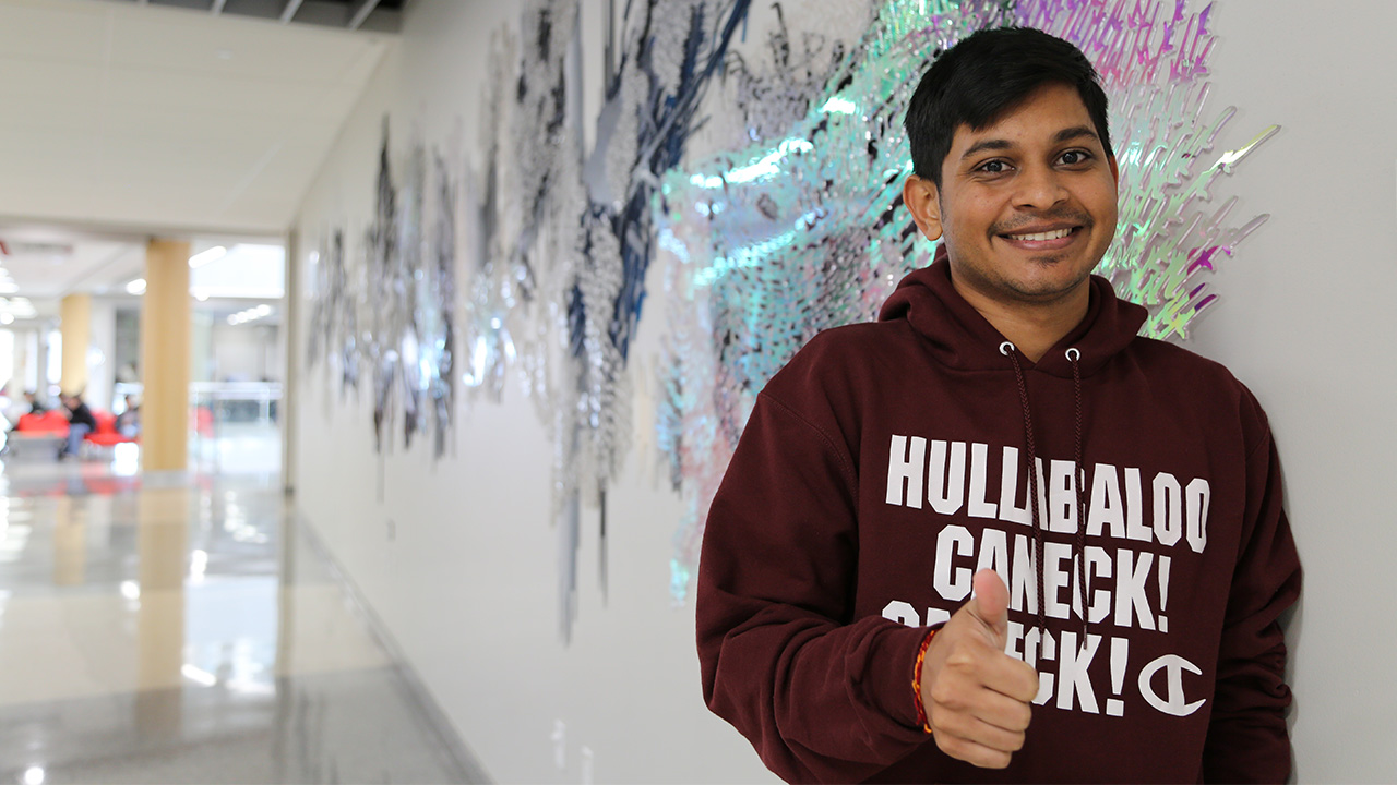 Yash Patel smiling with thumbs up