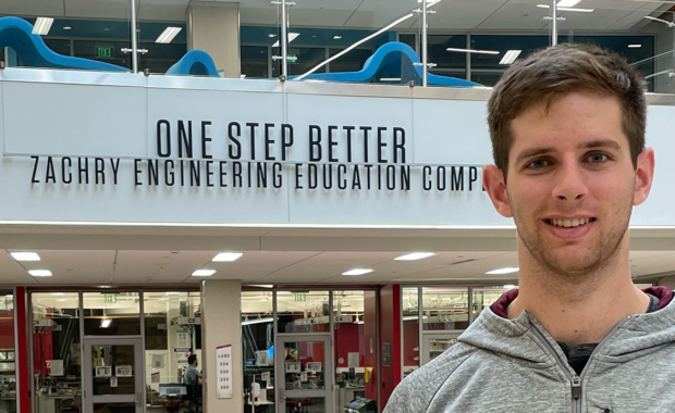 Austin in front of a sign