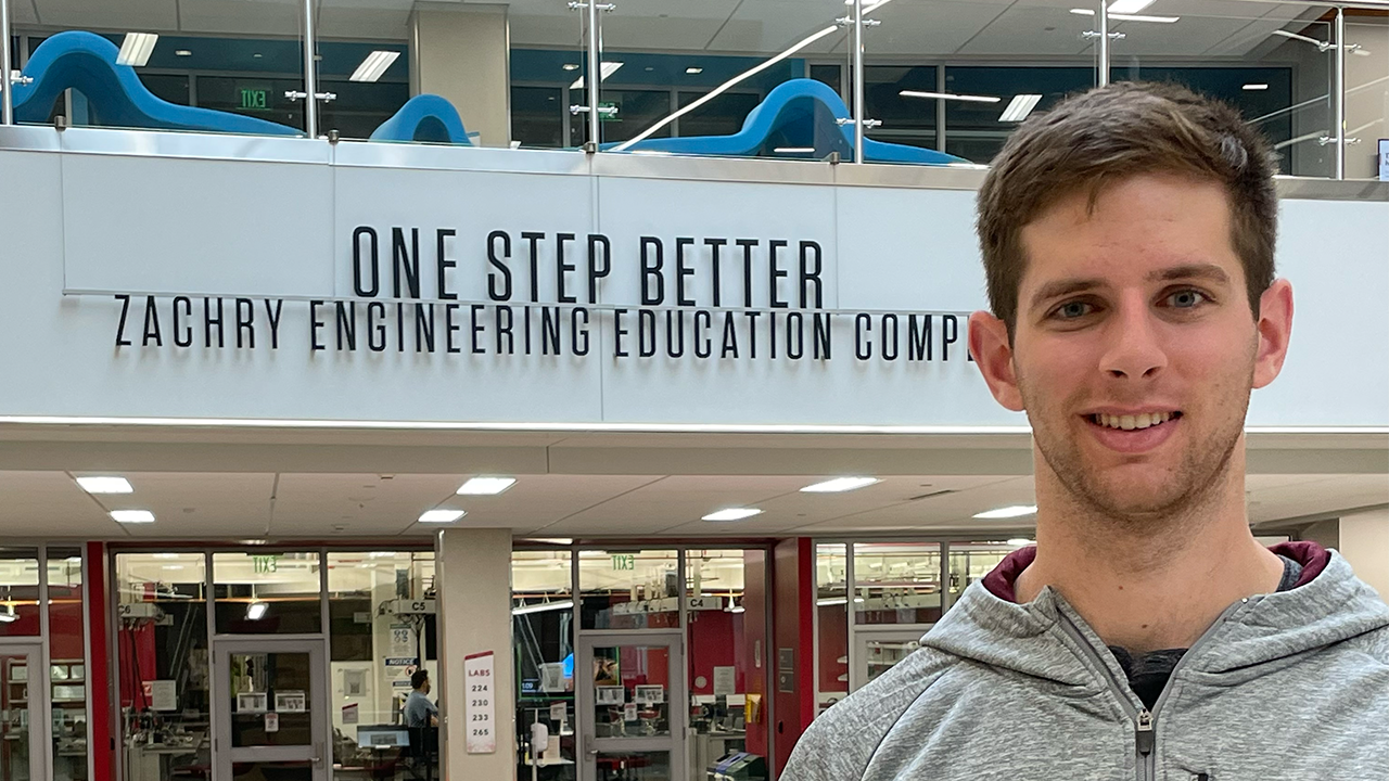 Austin in front of a sign