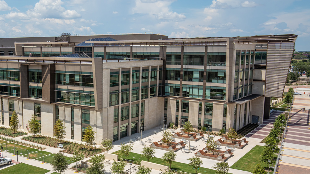 Blue, cloudy skies behind the Zachry Engineering Education Complex on a sunny day.