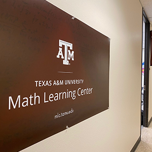 A "Texas A&M University Math Learning Center" sing on a blank wall.